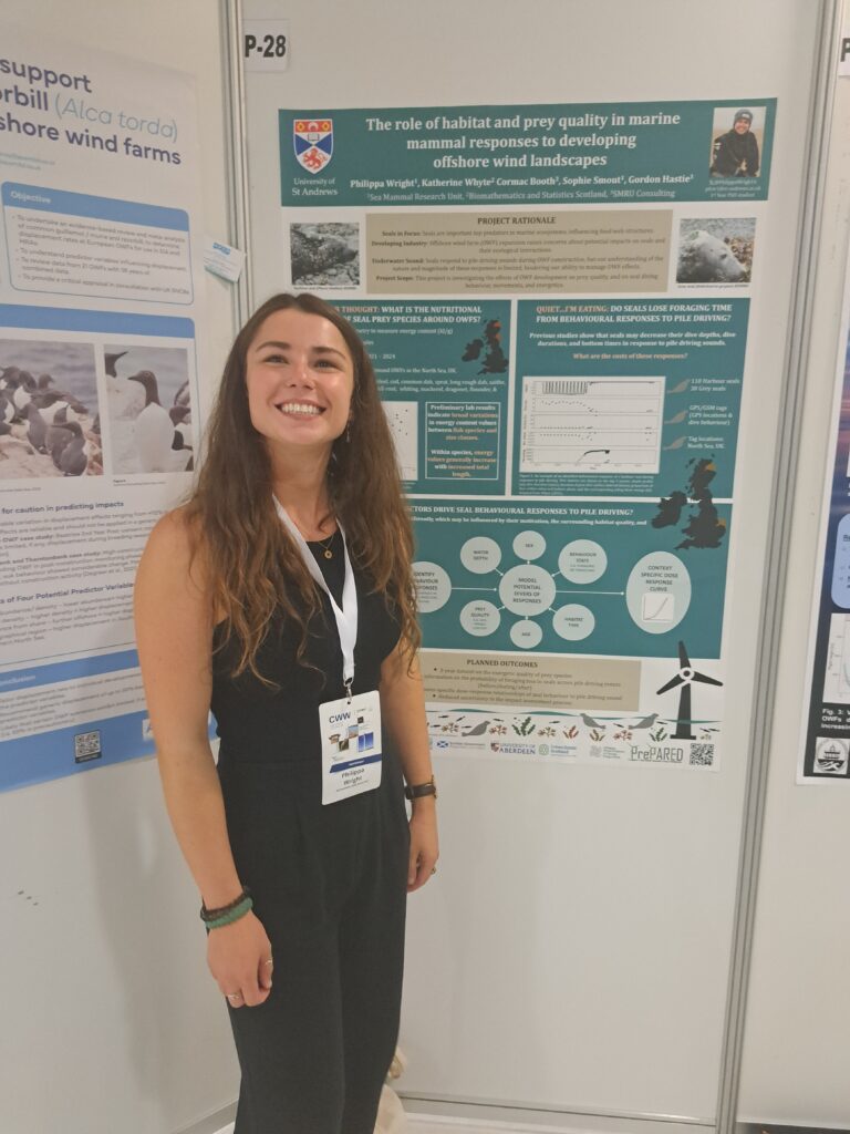 Project team member standing in front of poster on 'the role of habitat and prey quality in marine mammal responses to developing offshore wind landscapes'